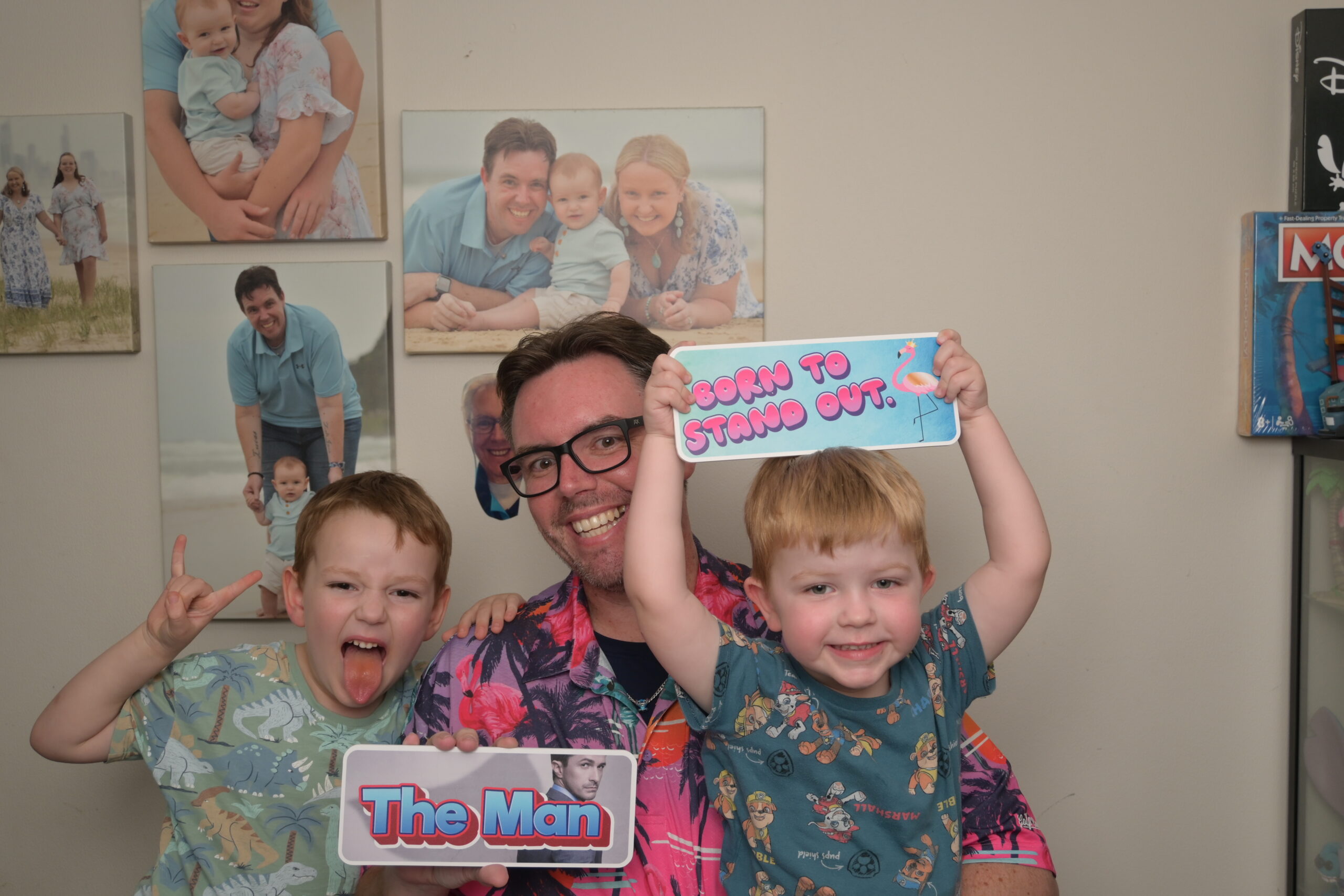 Guests posing and laughing in front of the photo booth.
