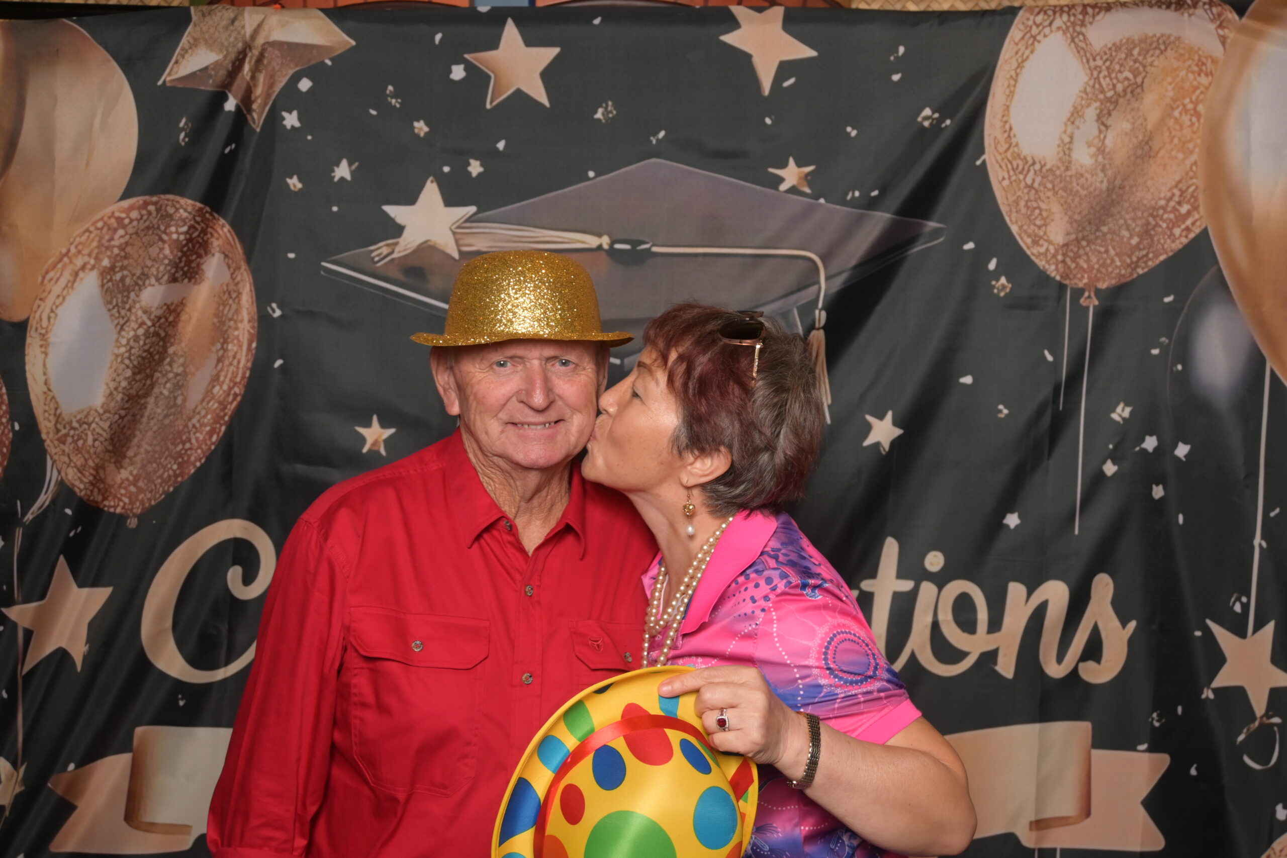 Students laughing in front of the booth